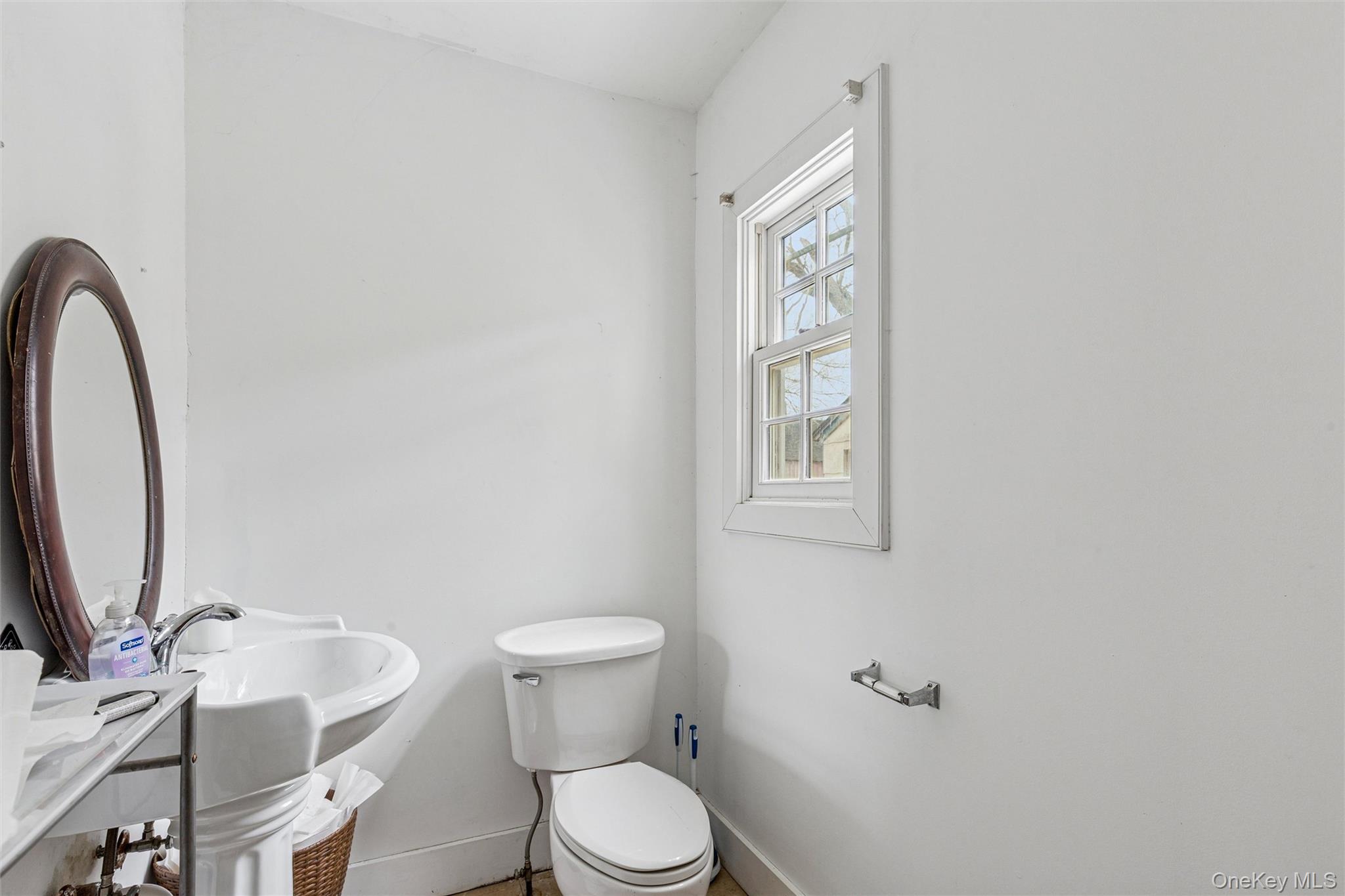 250 Main Road Riverhead, NY 11901 - Photo 11 of 31 a white toilet sitting next to a bathroom sink