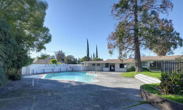 a view of a house with a yard and furniture