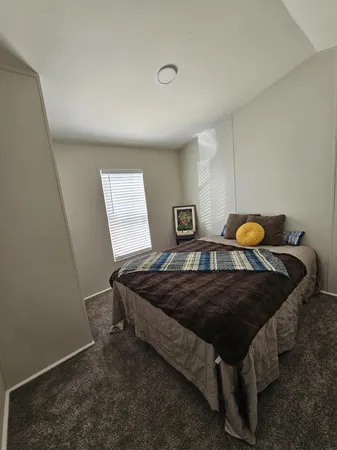 a bedroom with a bed and window