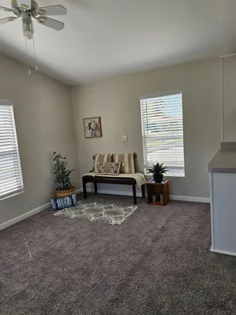a view of a room with gym equipment and a window