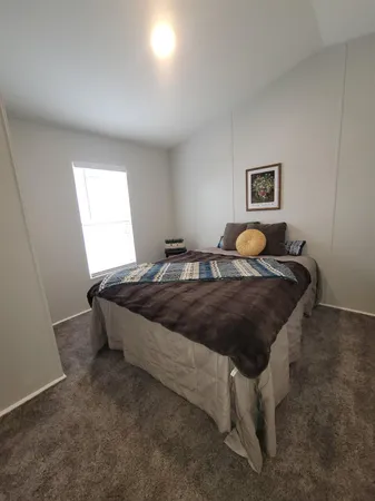 a bedroom with a bed and window