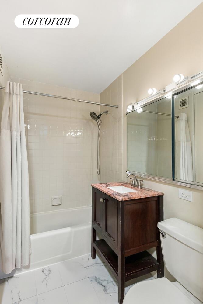 531 Main Street, Unit 1502 Manhattan, NY 10044 - Photo 10 of 11 a bathroom with a sink a toilet and shower