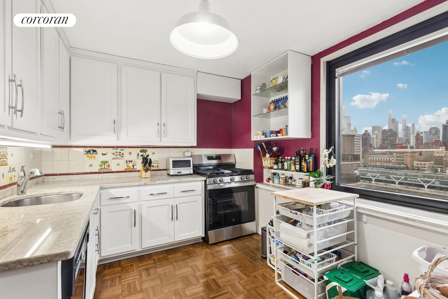 531 Main Street, Unit 1502 Manhattan, NY 10044 - Photo 5 of 11 a kitchen with a stove a sink and a refrigerator