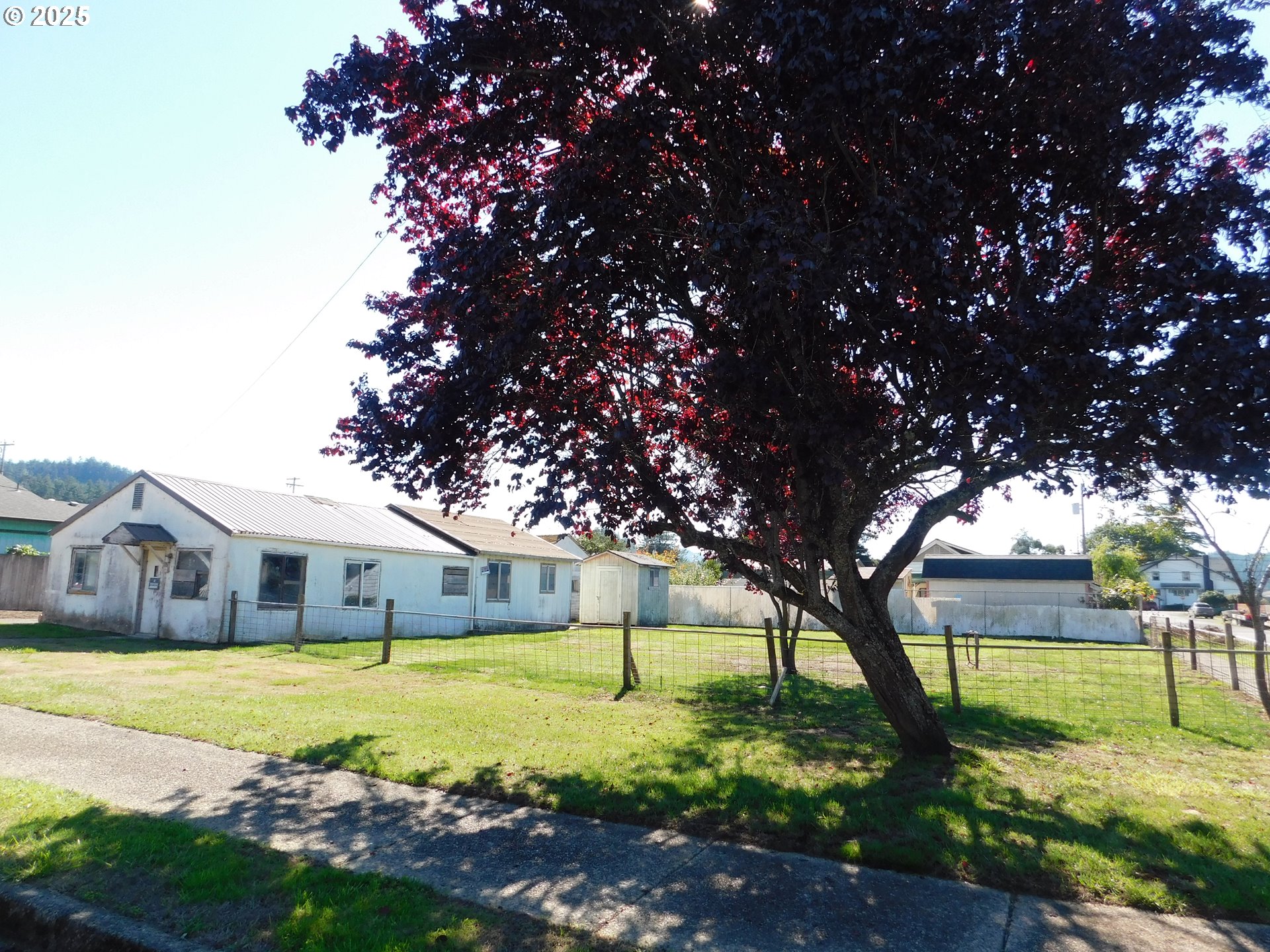 a swimming pool with trees in the background
