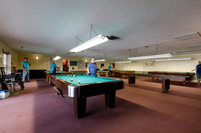 a room with table tennis pool table and chairs