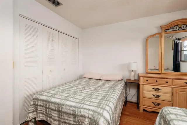 a bedroom with a bed and a dresser
