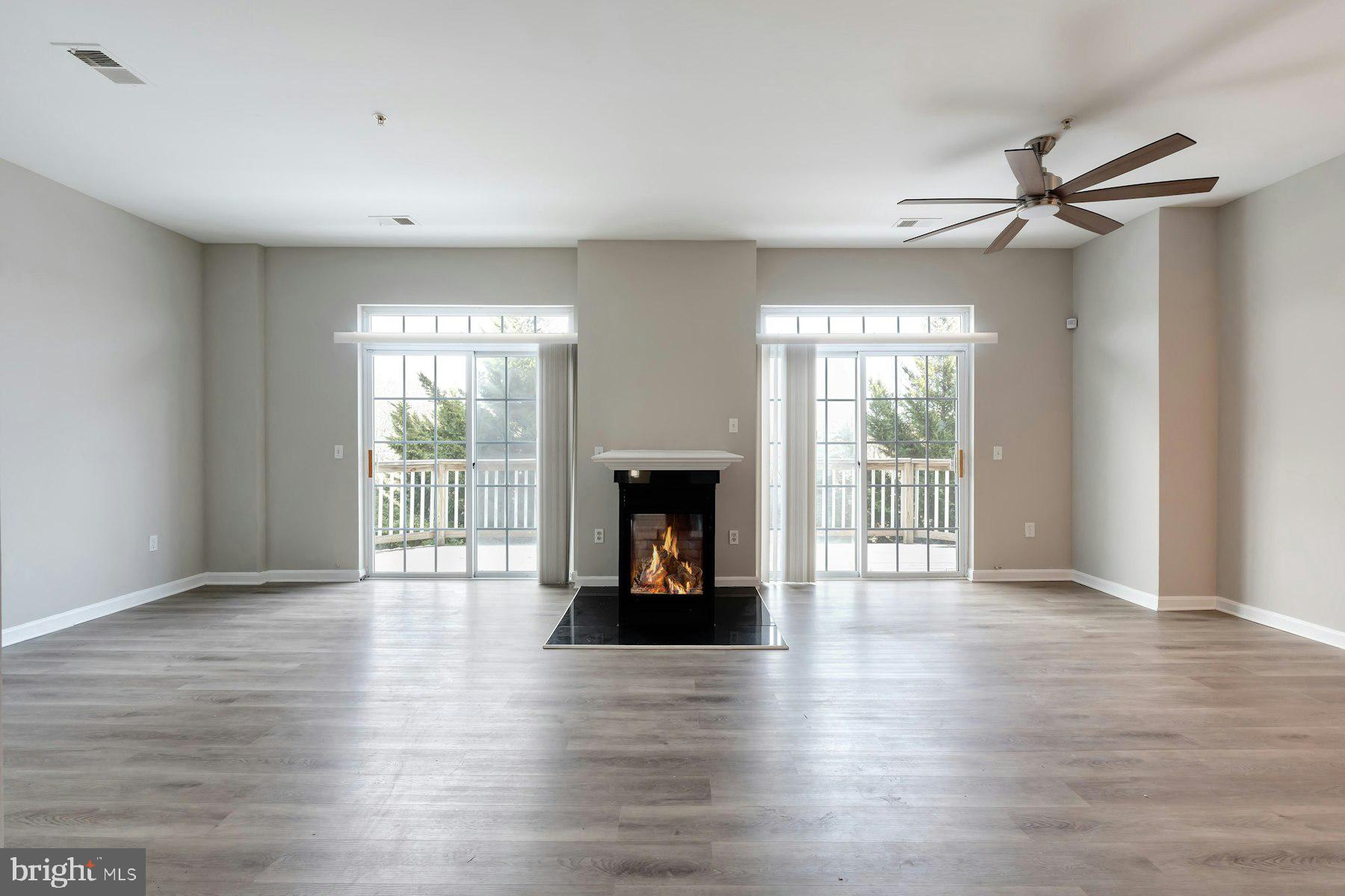 1838 Cedar Cove Way, Unit 201 Woodbridge, VA 22191 - Photo 11 of 38 a view of an empty room with wooden floor and a window