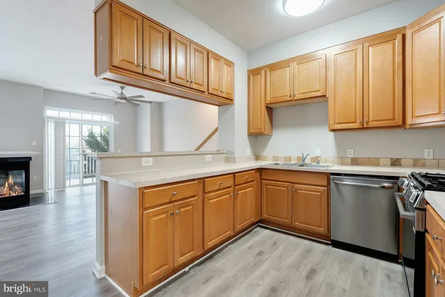 a kitchen with granite countertop cabinets stainless steel appliances a sink and a window
