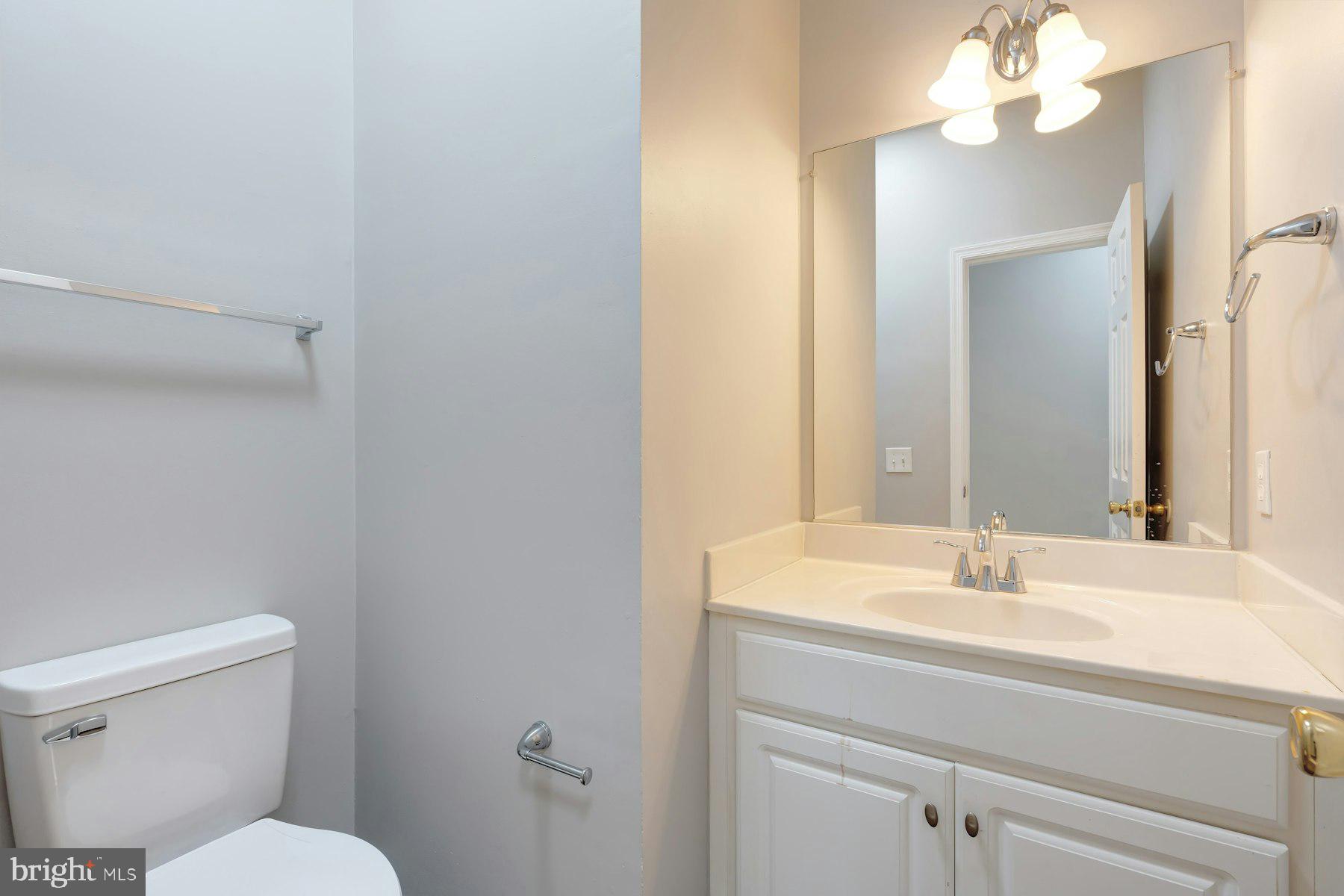1838 Cedar Cove Way, Unit 201 Woodbridge, VA 22191 - Photo 15 of 38 a bathroom with a sink vanity mirror and toilet