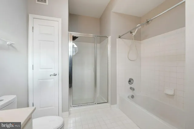 a bathroom with a shower and a toilet
