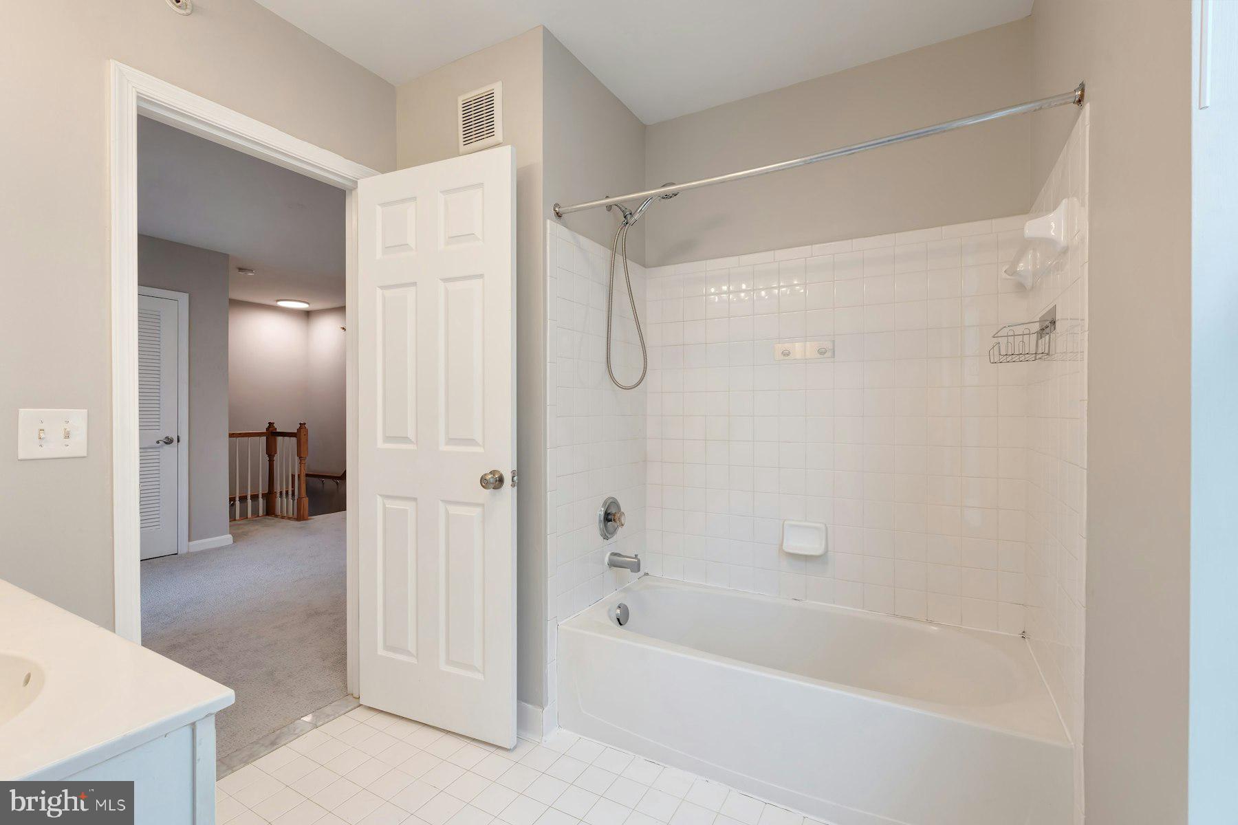 1838 Cedar Cove Way, Unit 201 Woodbridge, VA 22191 - Photo 29 of 38 a bathroom with a bathtub and a shower