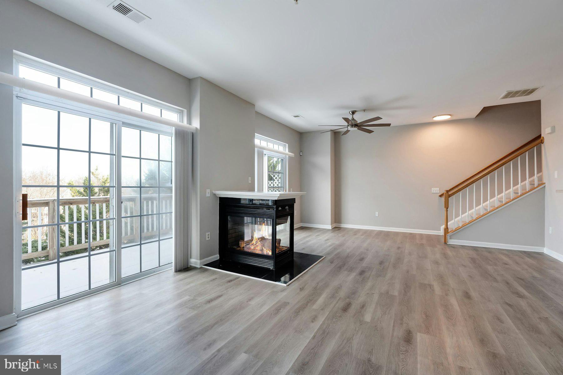 1838 Cedar Cove Way, Unit 201 Woodbridge, VA 22191 - Photo 6 of 38 a view of an empty room with wooden floor and a window