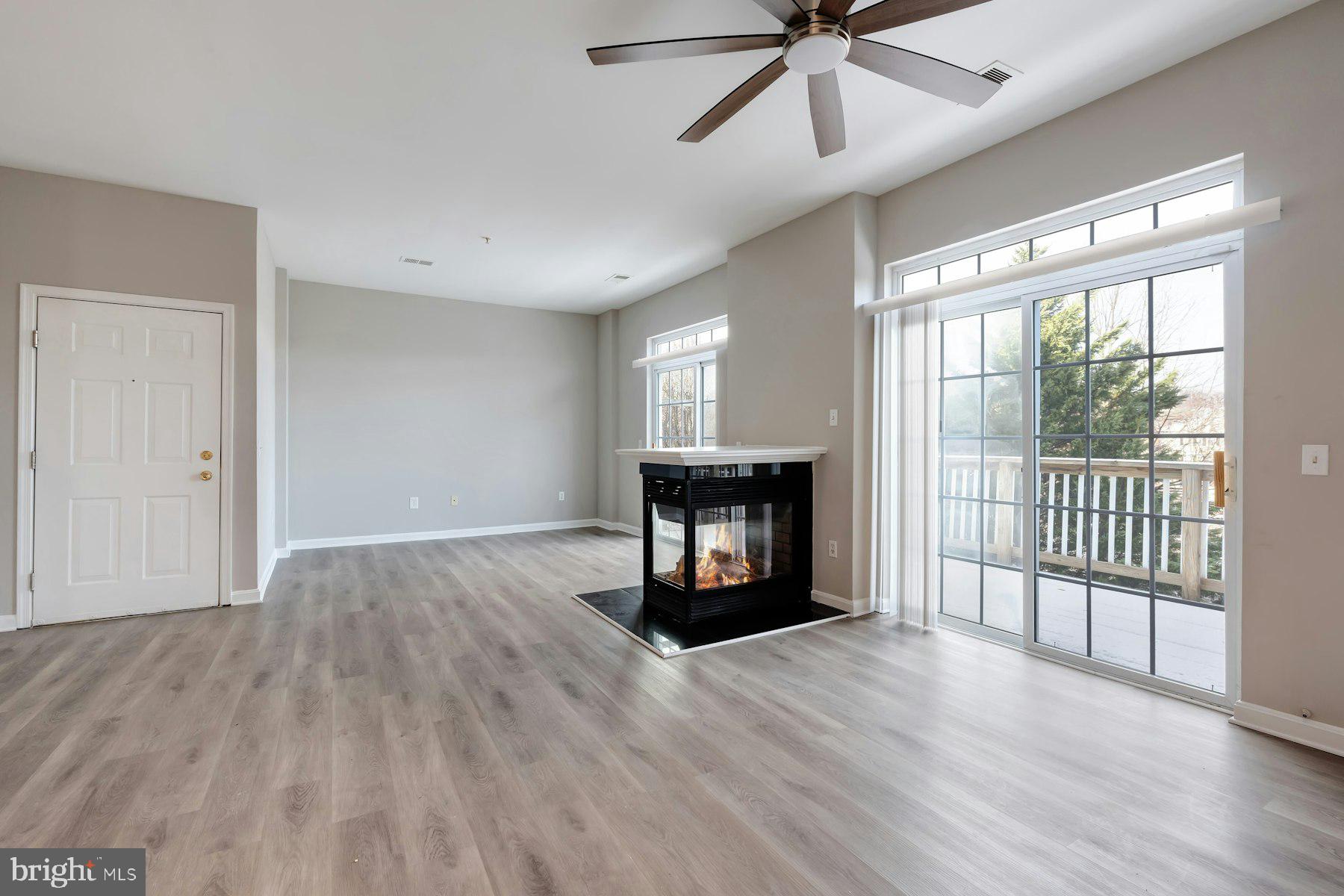 1838 Cedar Cove Way, Unit 201 Woodbridge, VA 22191 - Photo 9 of 38 a view of an empty room with a fireplace and a window