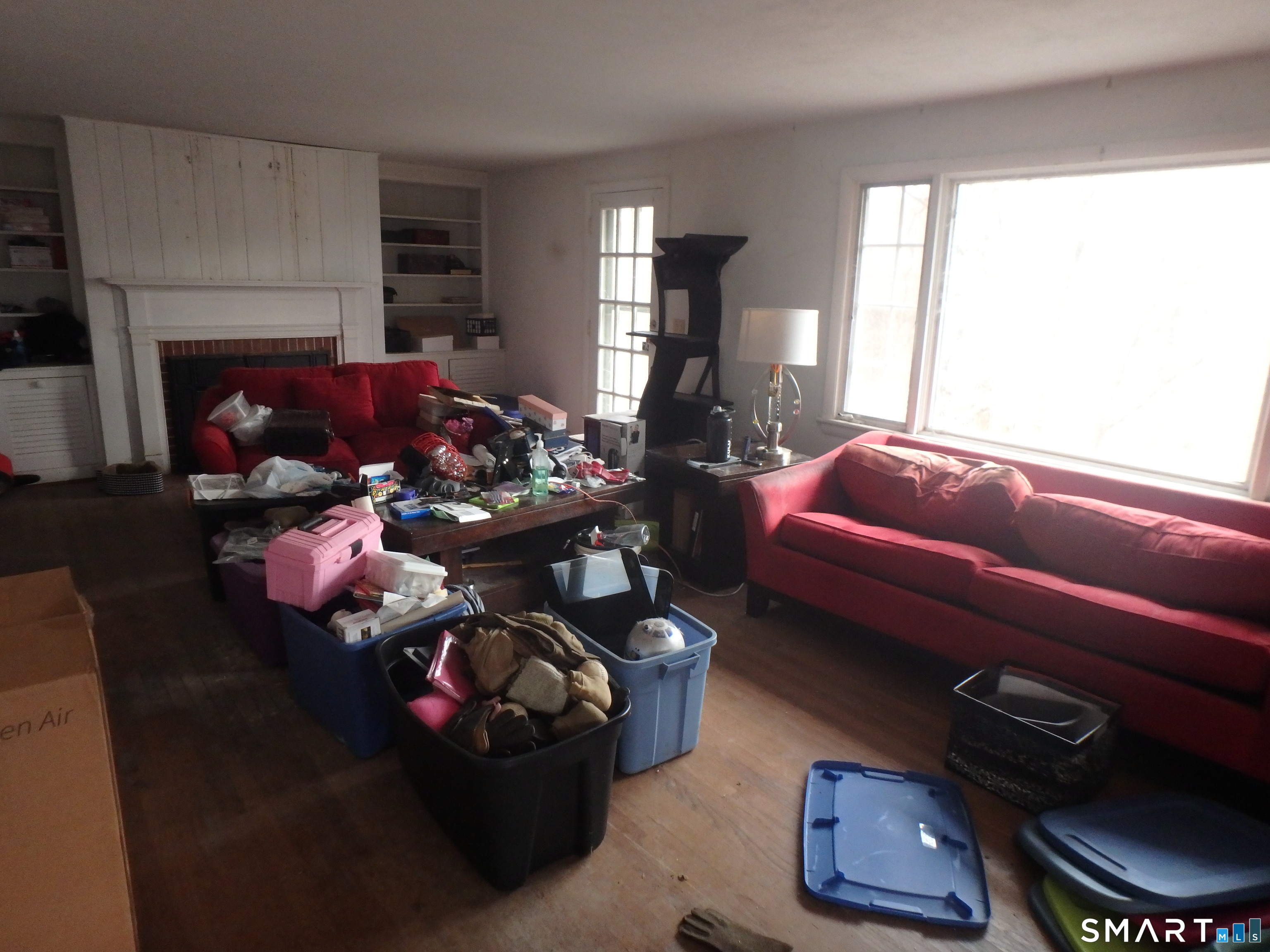 1918 Highway 12 Ledyard, CT 06335 - Photo 21 of 34 a living room with furniture a fireplace and a window
