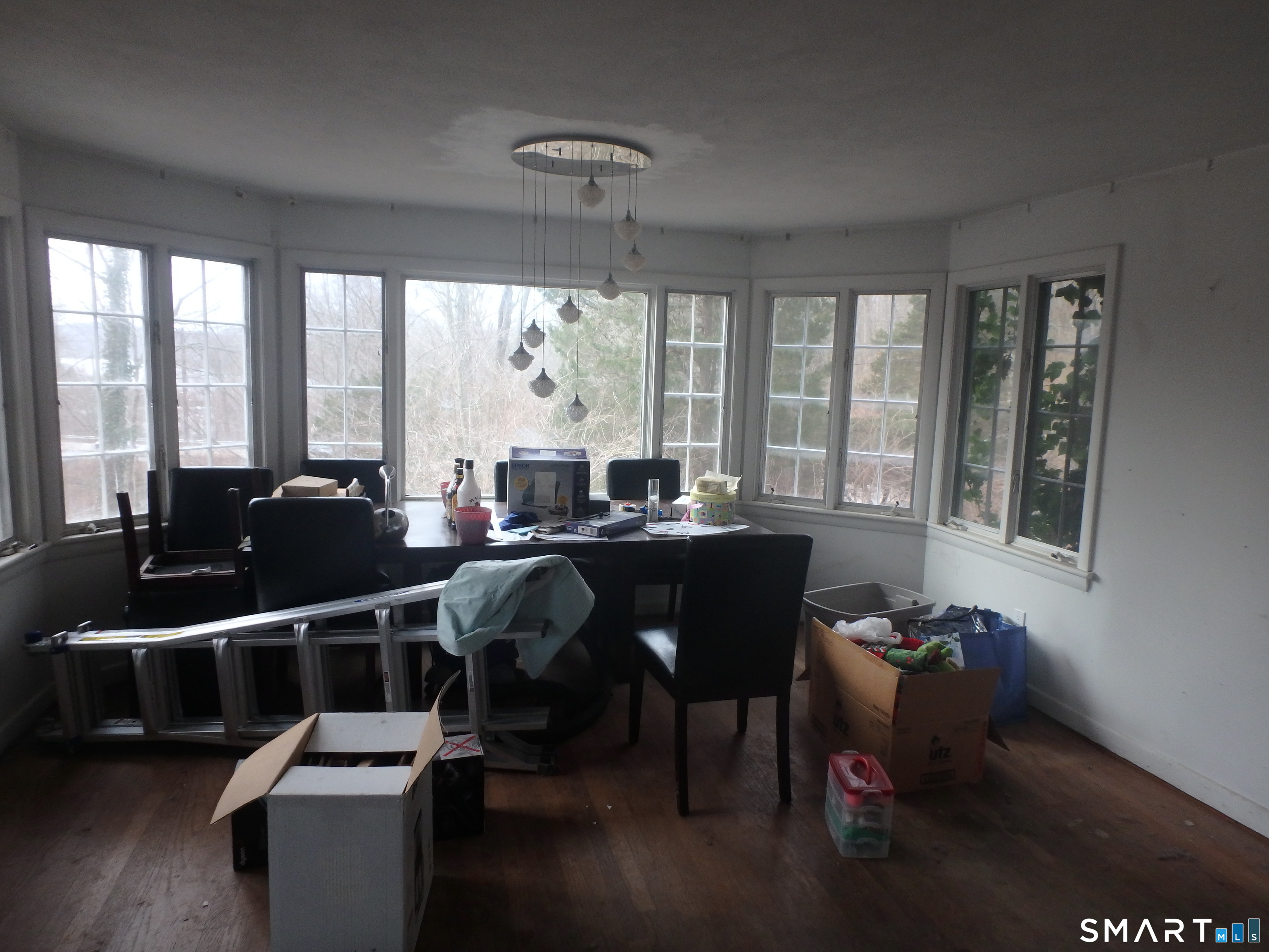 1918 Highway 12 Ledyard, CT 06335 - Photo 5 of 34 a view of a dining room with furniture large windows and wooden floor