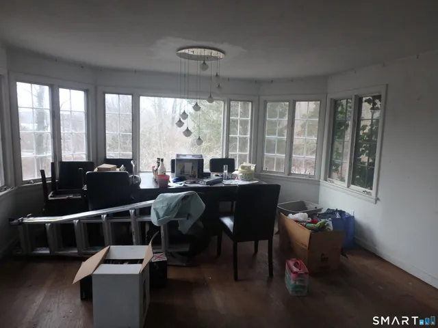 a view of a dining room with furniture large windows and wooden floor