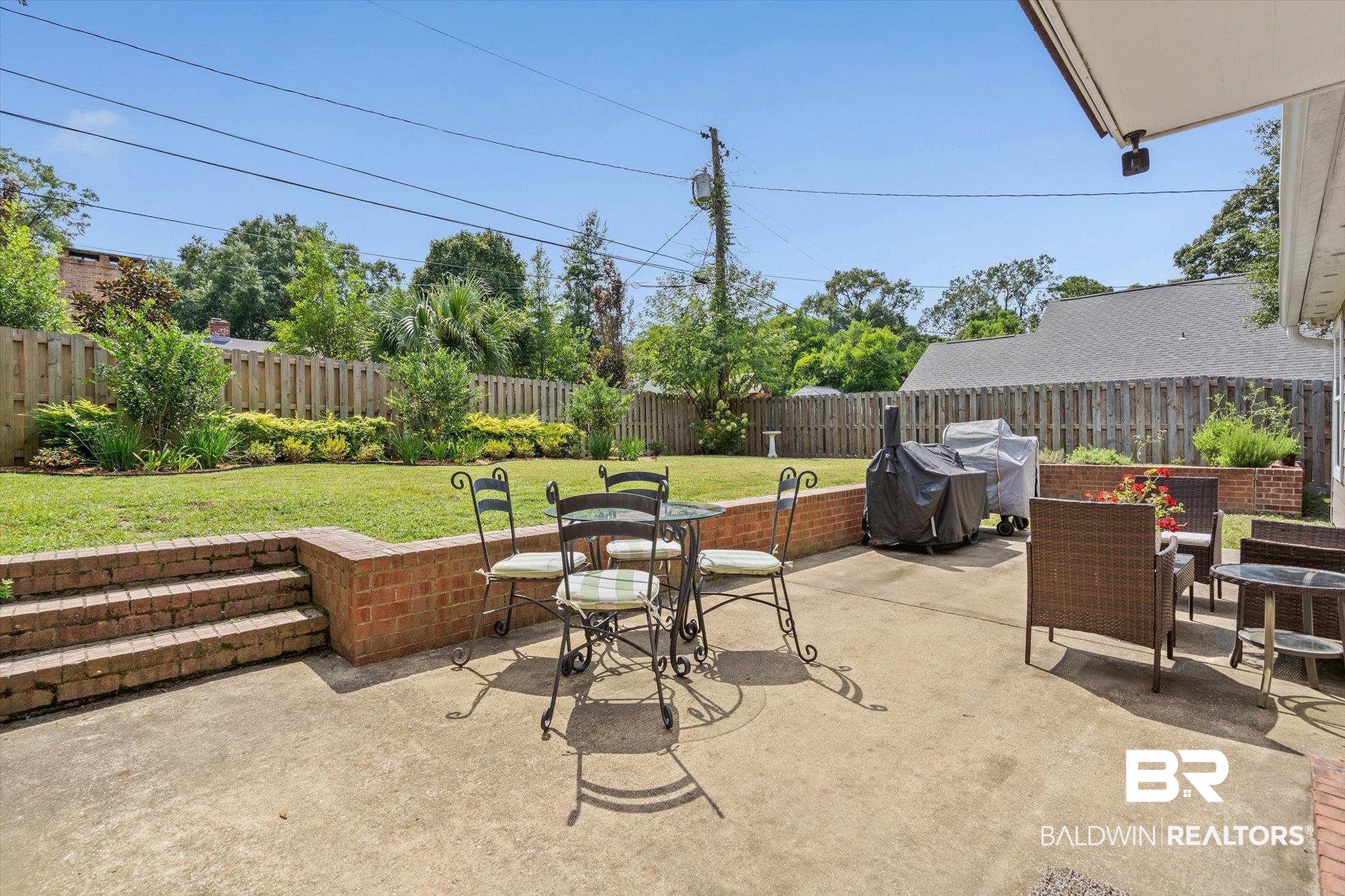 77 North Hathaway Road Mobile, AL 36608 - Photo 25 of 33 Fenced backyard featuring a patio area, a grill, and outdoor dining space
