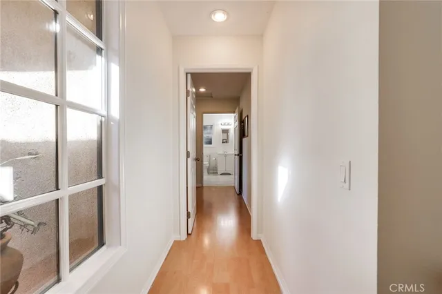 a view of hallway with wooden floor