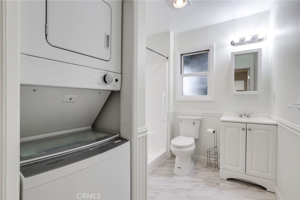 10485 Parakeet Circle Fountain Valley, CA 92708 - Photo 10 of 11 a view of bathroom with a toilet sink and mirror