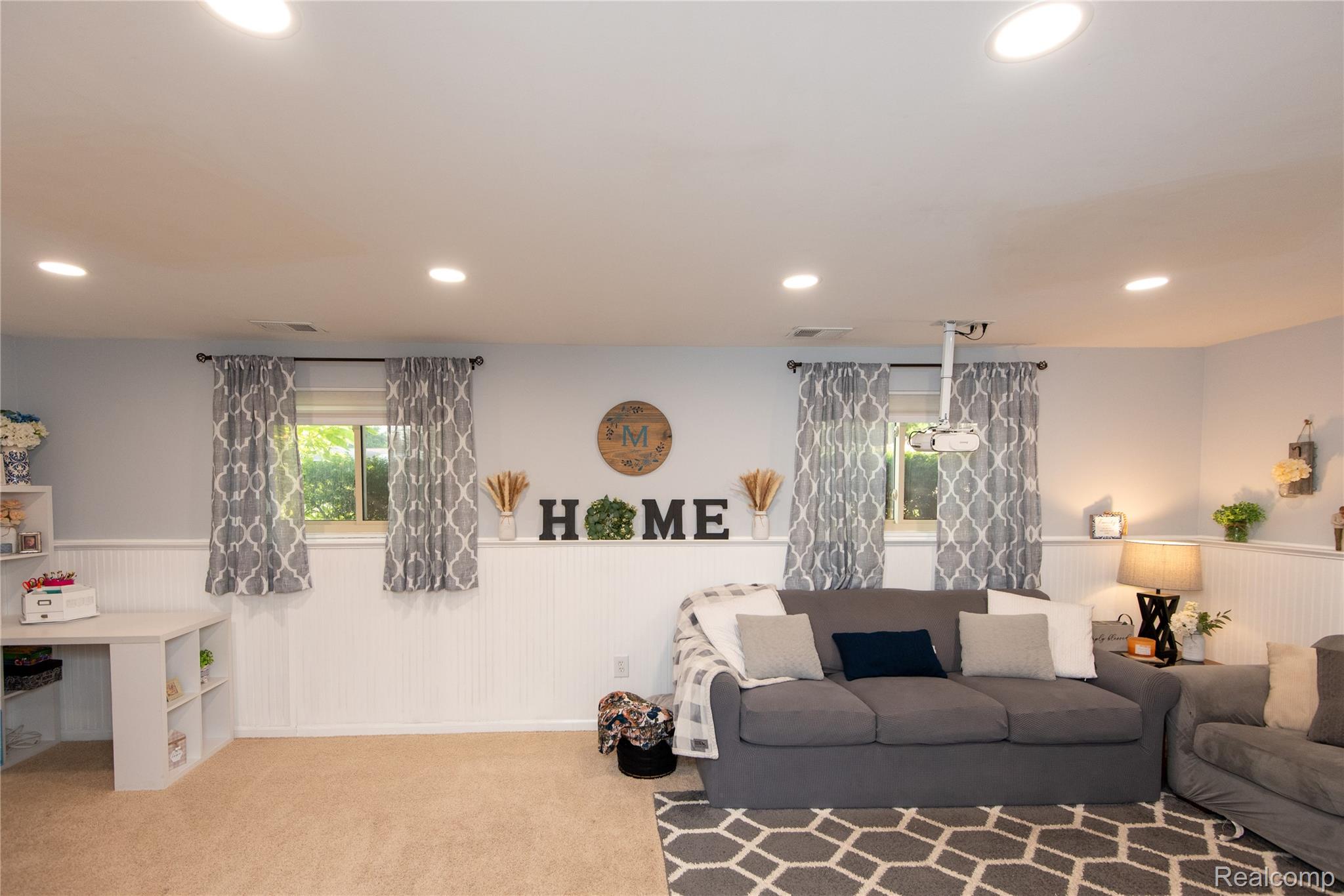 4395 Regency Road Swartz Creek, MI 48473 - Photo 31 of 67 Recessed lighting, light-toned carpeting, white wainscoting, and a ceiling-mounted projector