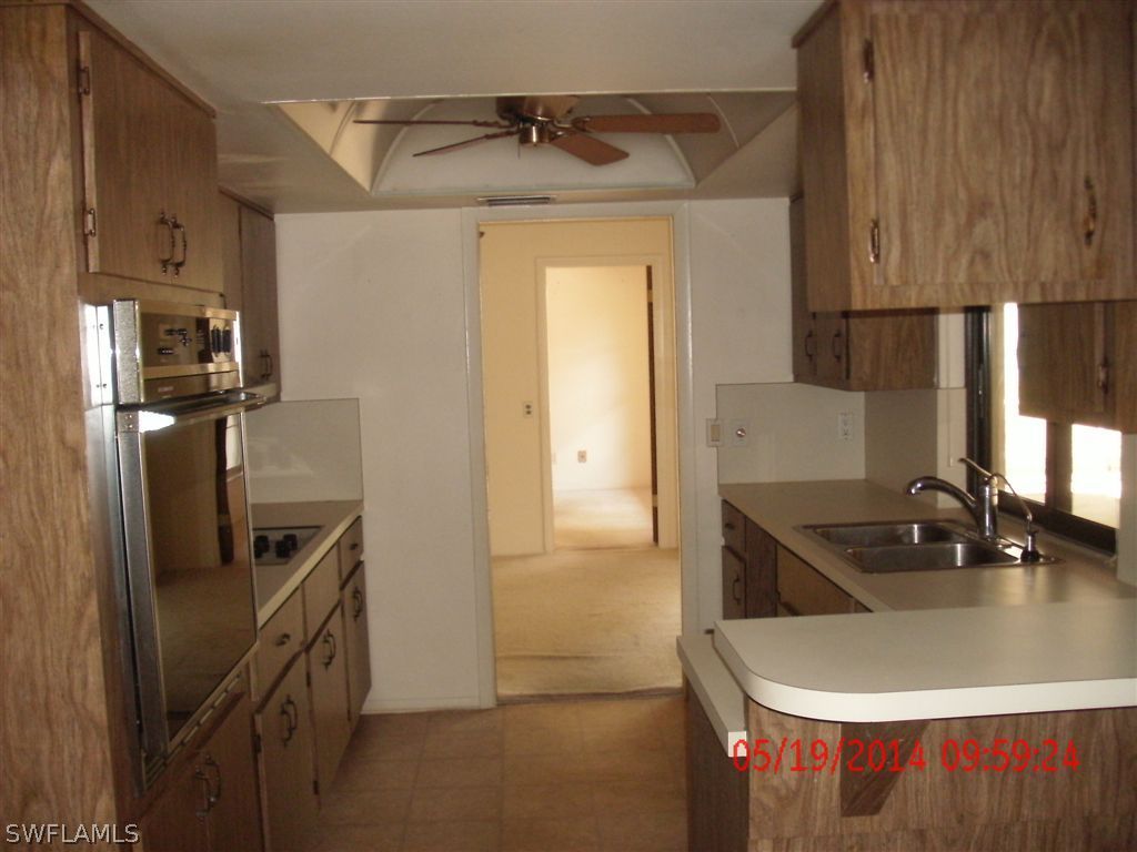 13851 River Road Fort Myers, FL 33905 - Photo 3 of 12 a kitchen with stainless steel appliances granite countertop a sink and a refrigerator