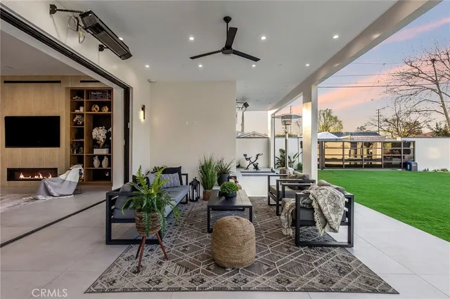 a view of a dining room with furniture and chandelier