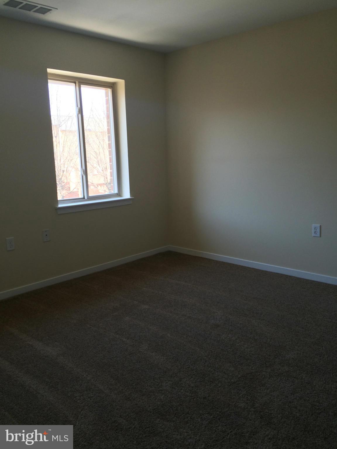 644 Charles Street, Unit R21 Baltimore, MD 21230 - Photo 3 of 7 an empty room with a window