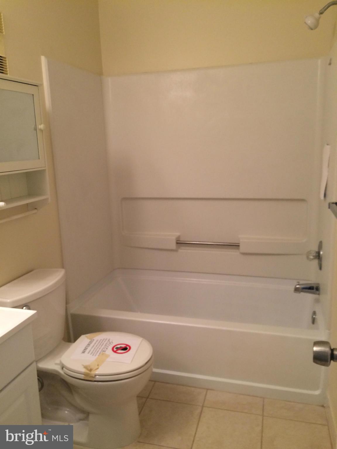 644 Charles Street, Unit R21 Baltimore, MD 21230 - Photo 5 of 7 a bathroom with a sink a toilet and a shower