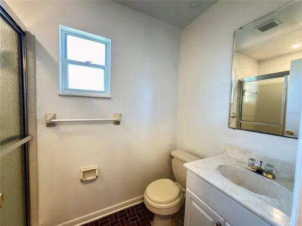 a bathroom with a sink toilet and mirror