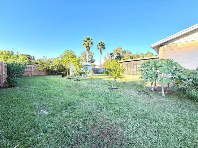 an aerial view of a house with a garden and swimming pool