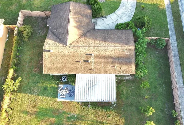 an aerial view of a house with a garden and swimming pool