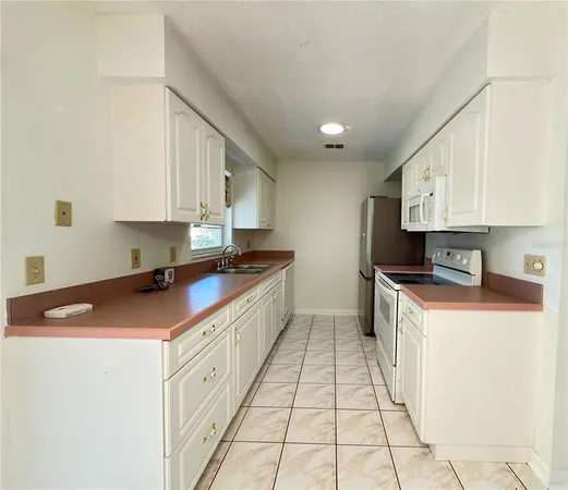 a kitchen with stainless steel appliances granite countertop a sink and a stove