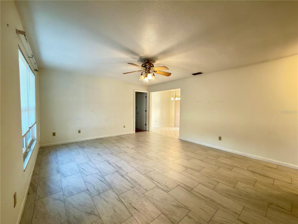 411 Parson Brown Way Longwood, FL 32750 - Photo 5 of 48 a view of a livingroom with a ceiling fan and window