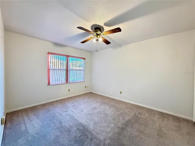 a bathroom with a granite countertop sink toilet mirror and shower