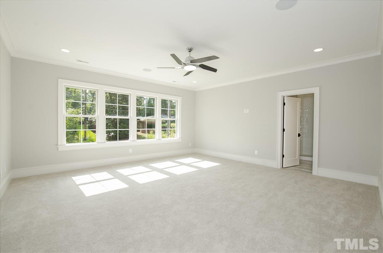 2325 Hathaway Road Raleigh, NC 27608 - Photo 22 of 25 an empty room with windows and ceiling fan view