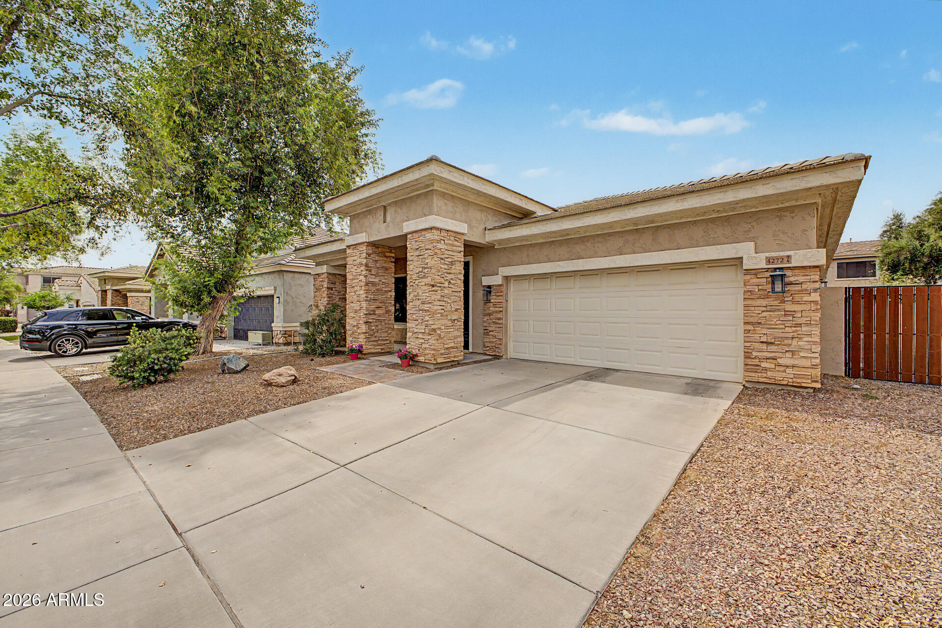 4272 East Buckboard Road Gilbert, AZ 85297 - Photo 5 of 37 a front view of a house with a yard and garage