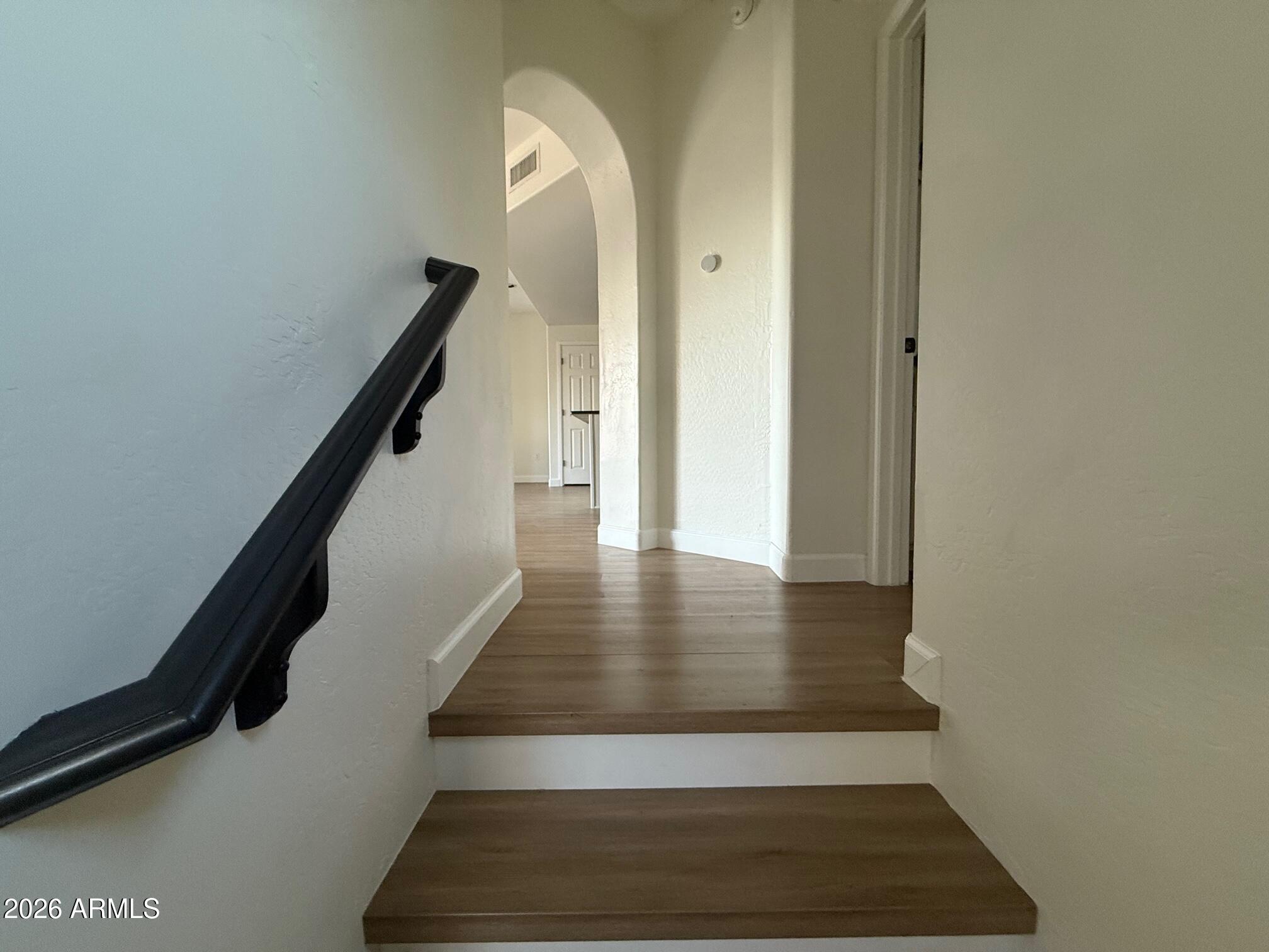 3935 East Rough Rider Road, Unit 1057 Phoenix, AZ 85050 - Photo 6 of 21 a view of entryway and hall with wooden floor