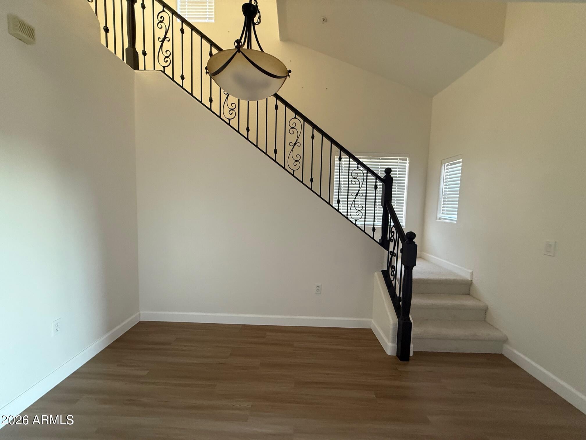 3935 East Rough Rider Road, Unit 1057 Phoenix, AZ 85050 - Photo 9 of 21 a view of entryway and hall with wooden floor