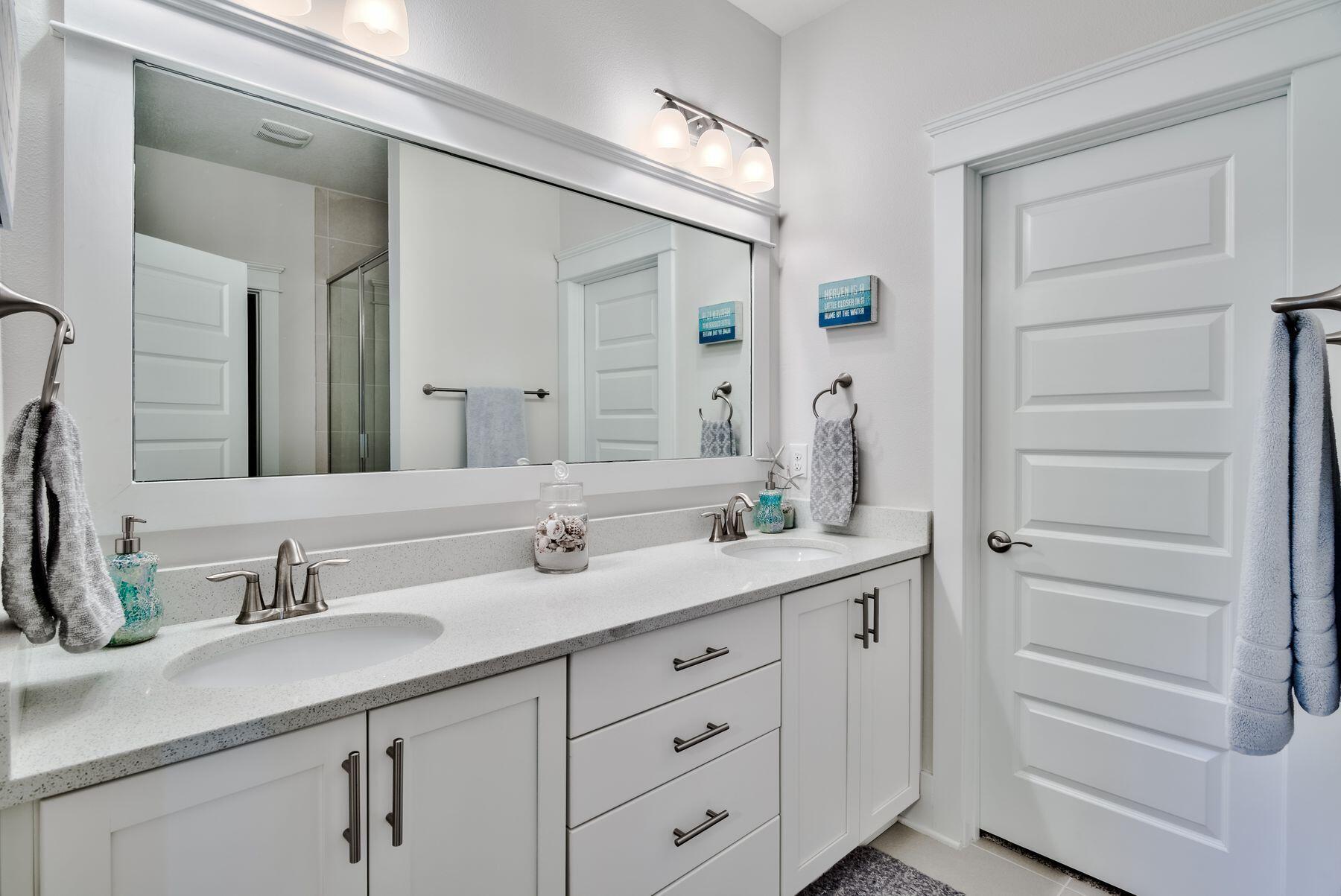 125 Grande Pointe Circle Inlet Beach, FL 32461 - Photo 15 of 30 a bathroom with a double vanity sink and a mirror