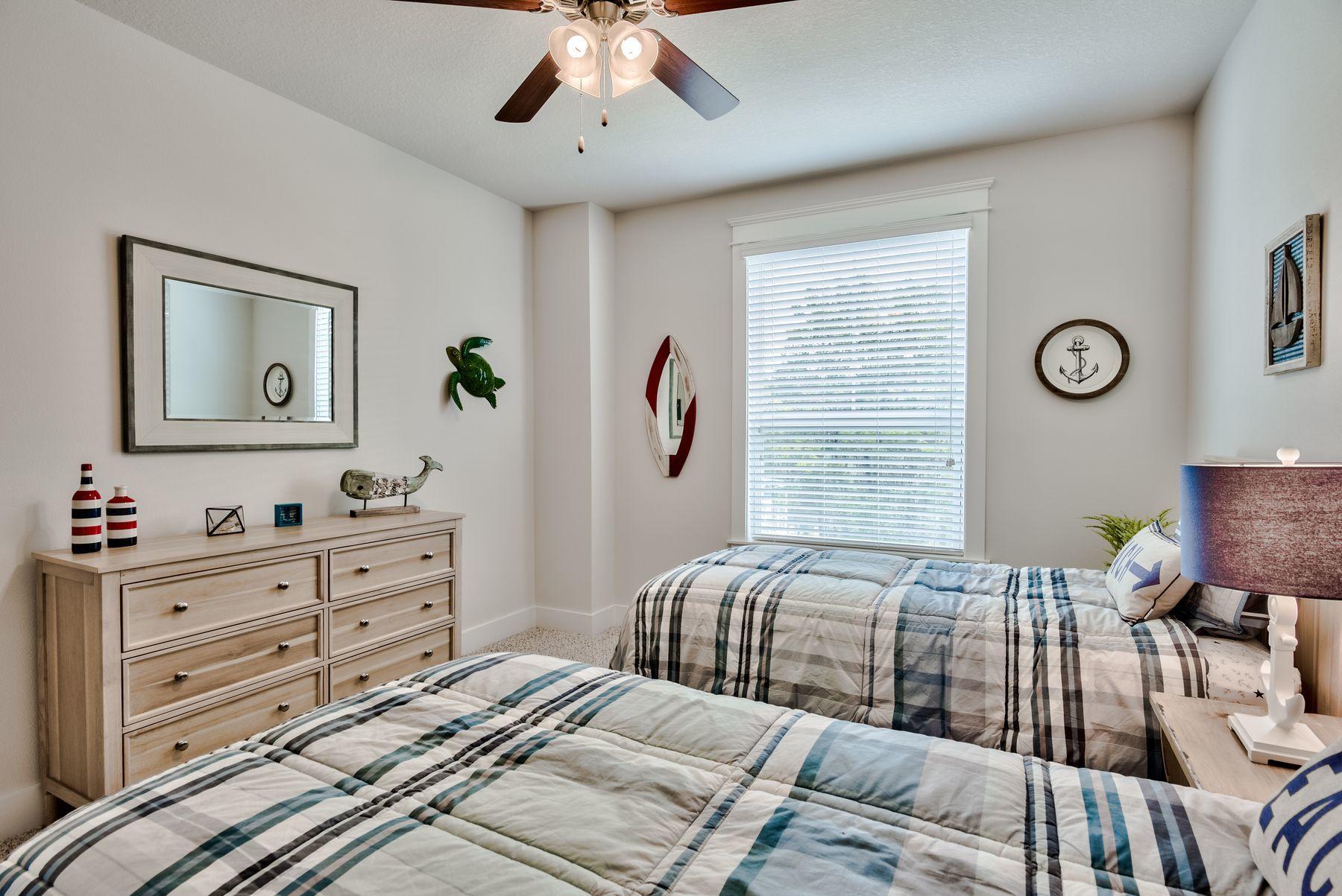125 Grande Pointe Circle Inlet Beach, FL 32461 - Photo 29 of 30 a bedroom with a bed and a chandelier
