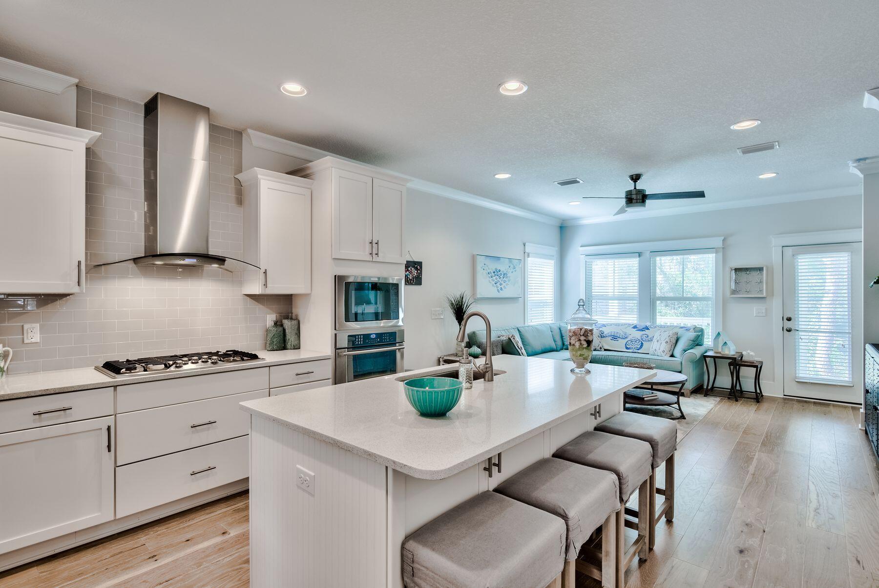 125 Grande Pointe Circle Inlet Beach, FL 32461 - Photo 3 of 30 a kitchen with stainless steel appliances a table chairs refrigerator and cabinets