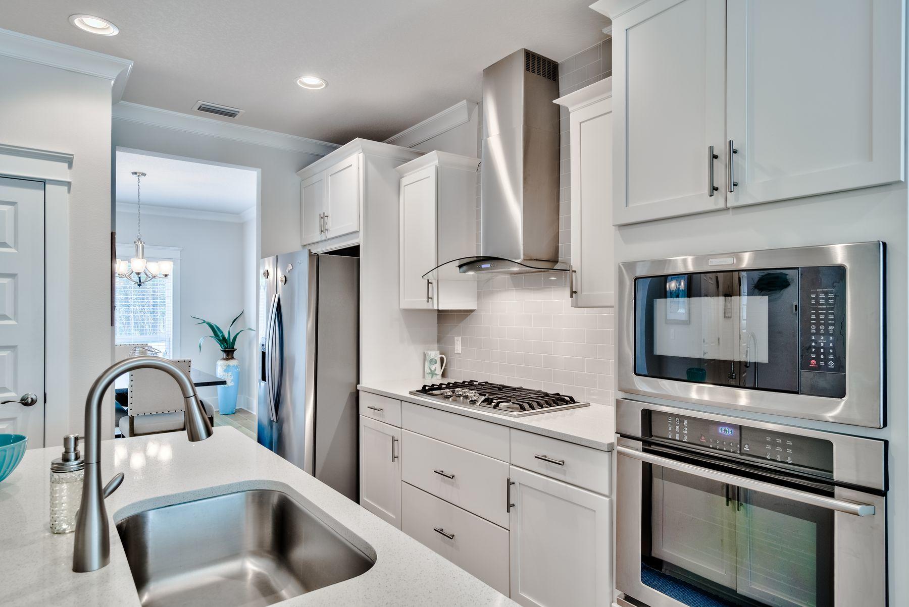 125 Grande Pointe Circle Inlet Beach, FL 32461 - Photo 8 of 30 a kitchen with granite countertop a sink stainless steel appliances and cabinets