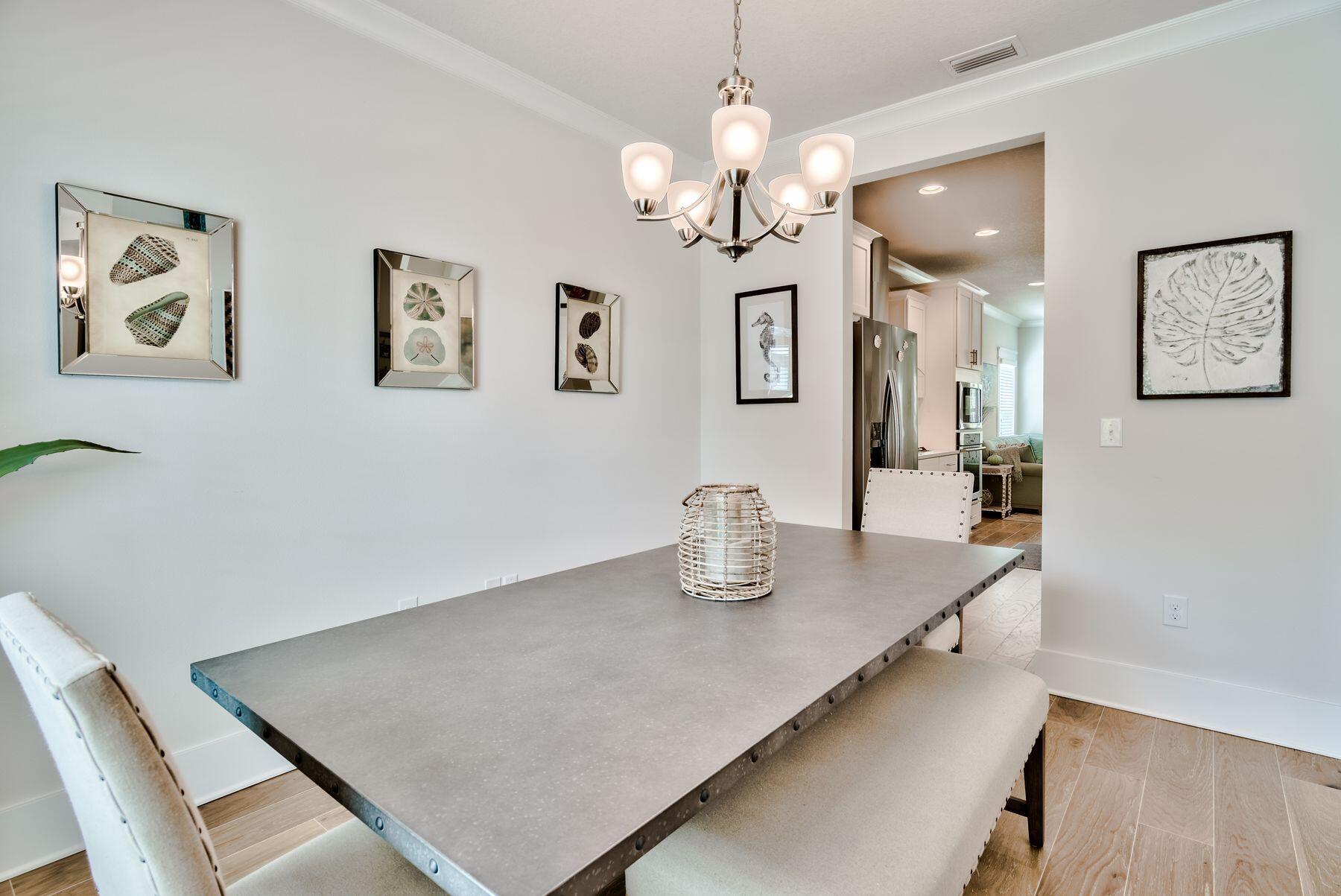 125 Grande Pointe Circle Inlet Beach, FL 32461 - Photo 10 of 30 a view of a dining room with furniture and chandelier