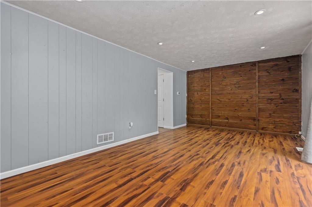 706 Countryside Drive McKees Rocks, PA 15136 - Photo 11 of 23 a view of empty room with wooden floor and cabinet