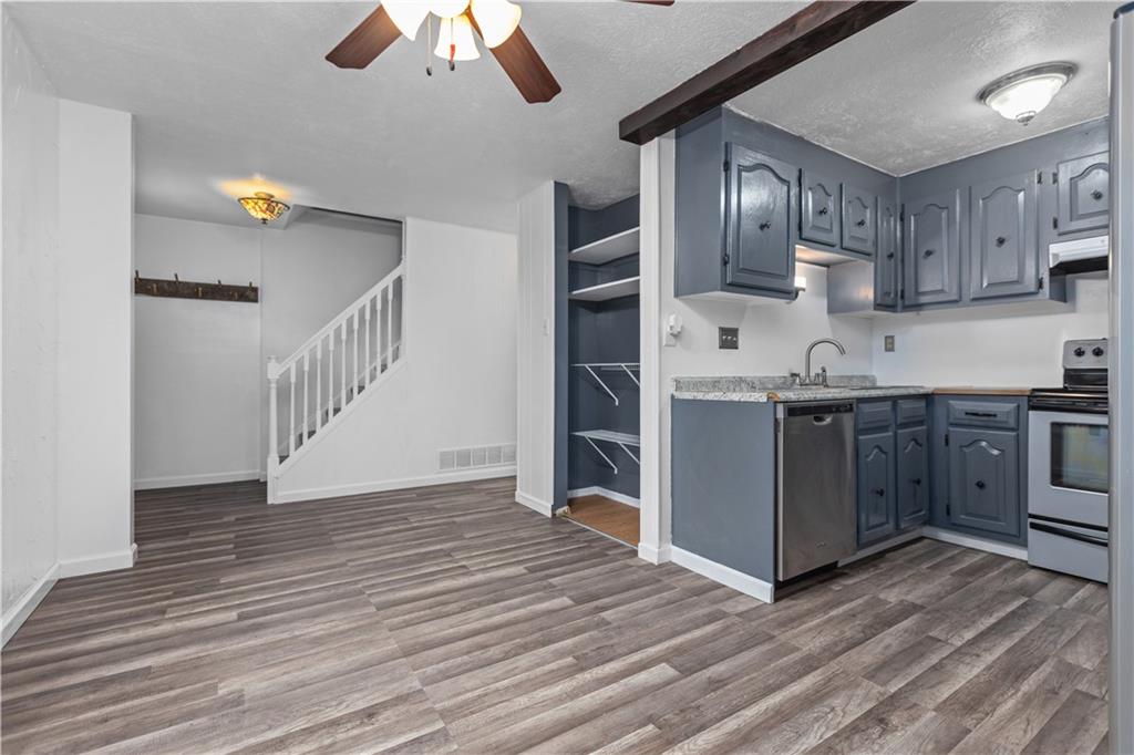 706 Countryside Drive McKees Rocks, PA 15136 - Photo 4 of 23 a view of a kitchen with a sink cabinets and wooden floor