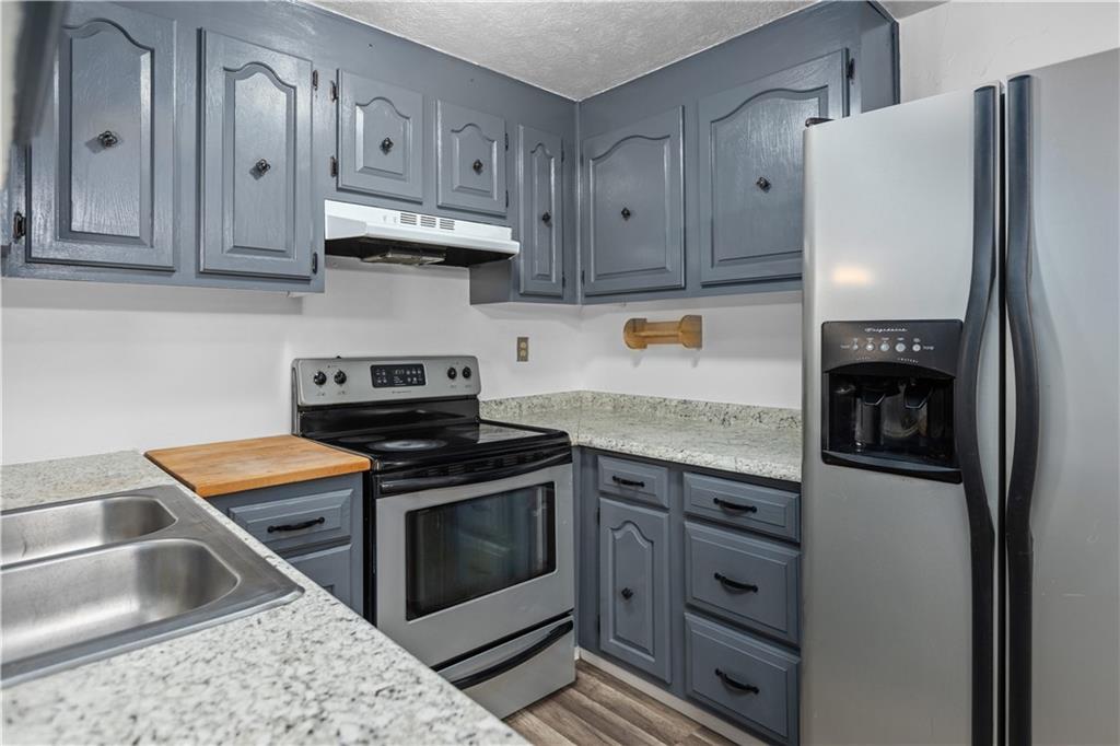 706 Countryside Drive McKees Rocks, PA 15136 - Photo 5 of 23 a kitchen with granite countertop a stove sink and cabinets