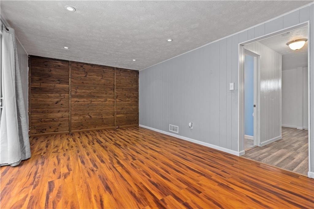 706 Countryside Drive McKees Rocks, PA 15136 - Photo 10 of 23 a view of an empty room with wooden floor and a bathroom