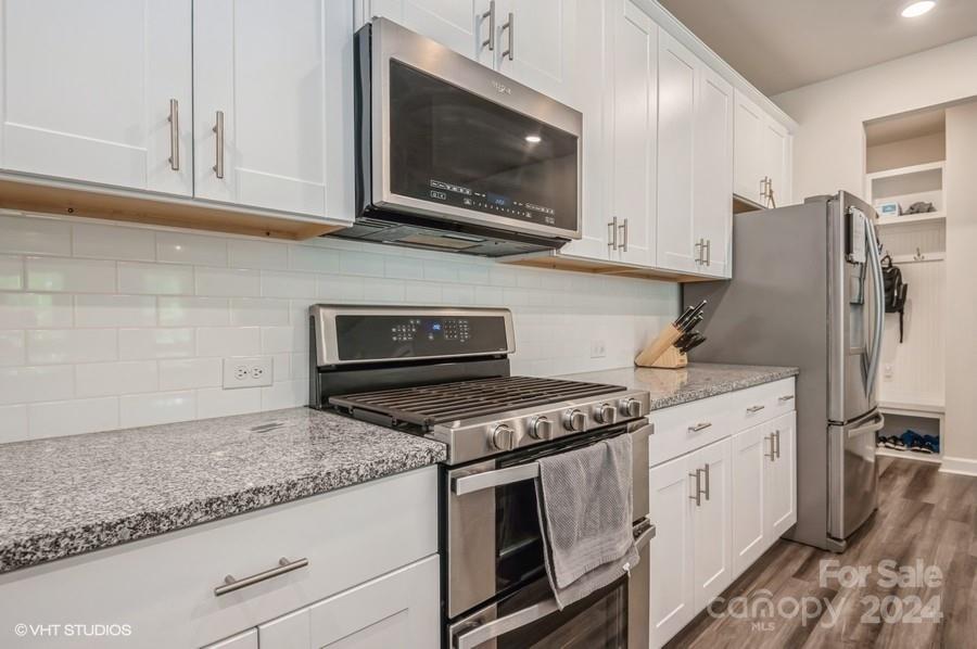11955 Old Statesville Road Huntersville, NC 28078 - Photo 12 of 39 a kitchen with stainless steel appliances granite countertop a stove a microwave and a refrigerator