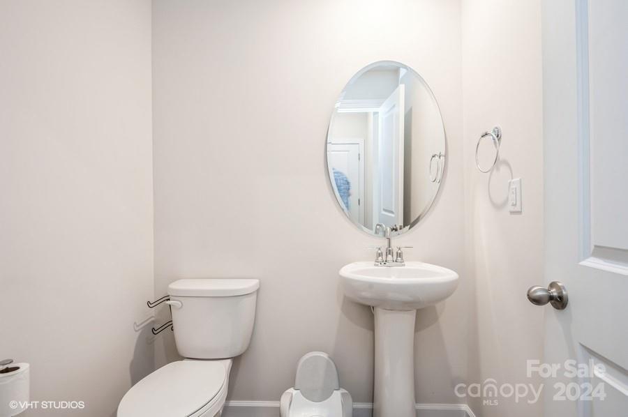 11955 Old Statesville Road Huntersville, NC 28078 - Photo 17 of 39 a bathroom with a toilet sink and mirror