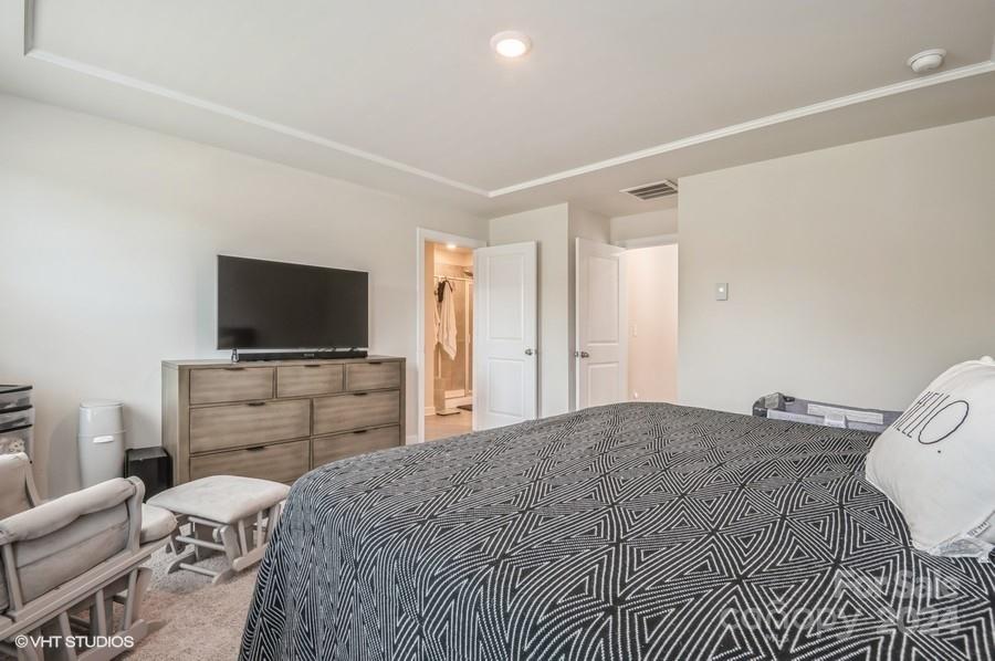 11955 Old Statesville Road Huntersville, NC 28078 - Photo 20 of 39 a bedroom with a bed and a flat screen tv